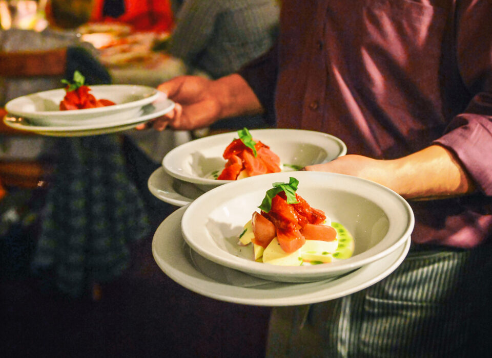 Waiter serving meal