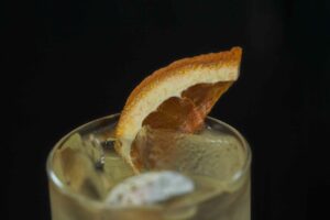 cocktail garnished with fruit slice